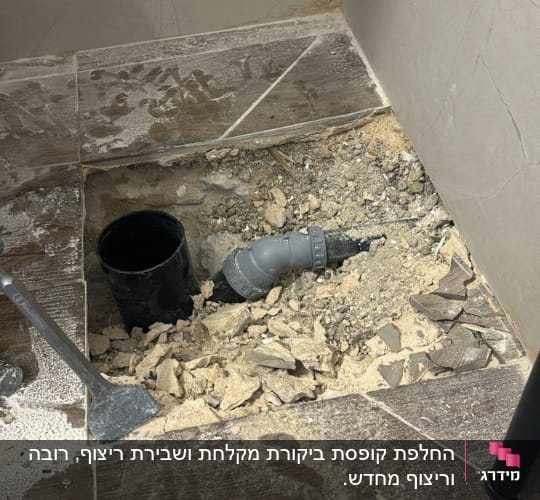 צינור פלסטיק שחור ואפור בתוך חור ברצפה